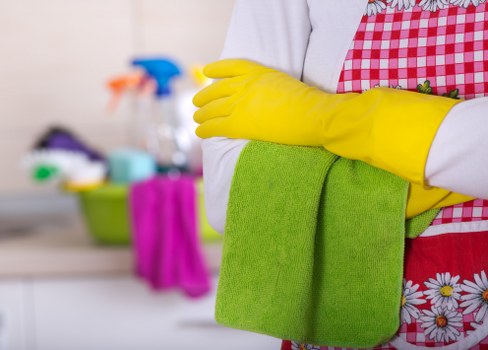 Professional carpet cleaners treating stains in a busy room